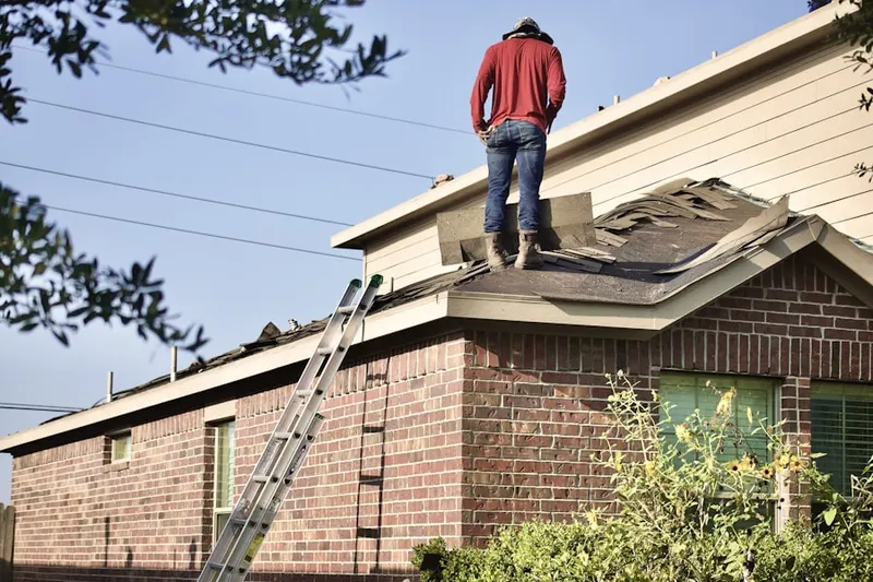 Professional roofer working on a residential roof in Storrs
